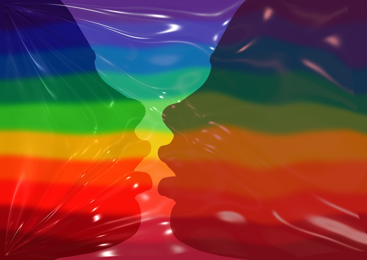 kissing faces on the LGBT rainbow colored pride flag
